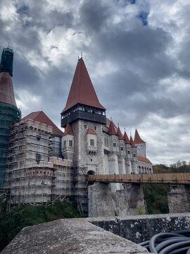 Hunedoara, Romania - October 28, 2025 - Corvin Castle with fortified stone walls and pointed Gothic towers, medieval heritage landmark, cultural travel destination.