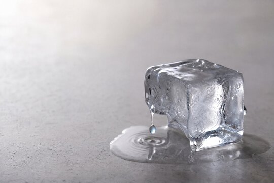 Melting Ice Cube With Water Droplet and Copy Space