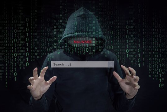Hacker in hoodie with binary code background. Cybersecurity threat concept