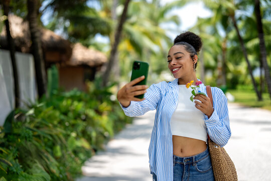 Successful female freelancer taking a creative break in a tropical paradise on summer vacation
