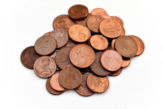 One, Two and Five euro cent coins on white. Selective focus.