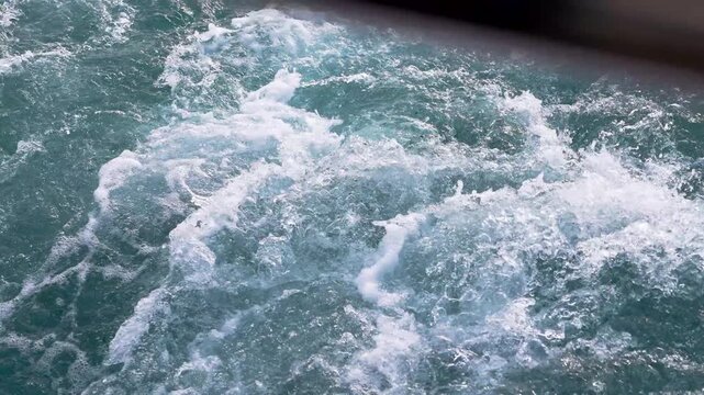 Close up view of the wake, back waves of a sailing boat.