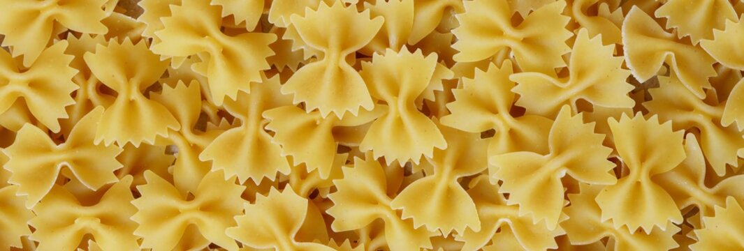 Top View Of Raw Uncooked Farfalle Bow Tie Pasta Texture Background