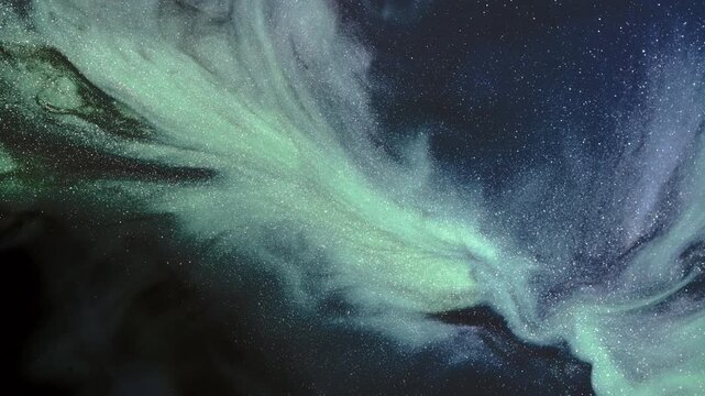 Metallic ink drifts in sweeping, aurora-like plumes over a speckled, starfield-style liquid surface in macro detail.