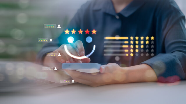 A customer using smartphone to give a five star rating and positive feedback review with virtual smiley face icon for excellent client service satisfaction and quality experience evaluation.