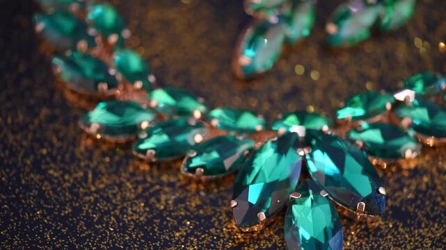 Closeup of luxury jewelry, emerald gemstone necklace and earrings. Woman fashion precious stone accessories jewels. 