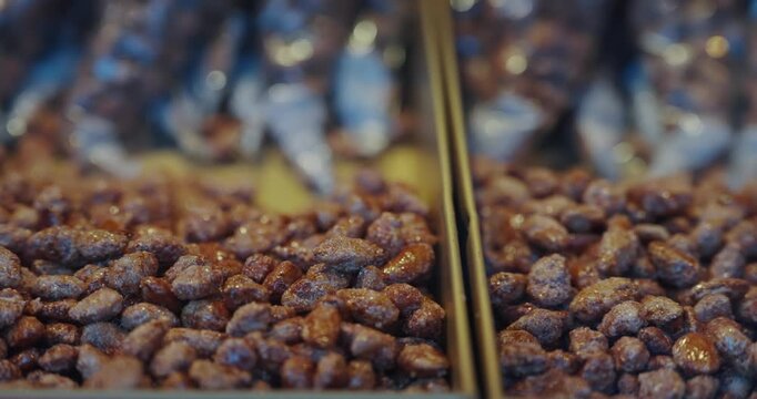 A bunch of bags of nuts and pistachio candies are displayed in a store at Christmas market in Cologne, Germany