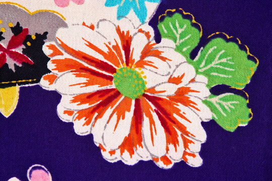 Orange chrysanthemum close-up on purple vintage kimono fabric