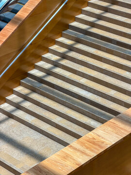 Stone Staircase with Wood Paneling and Diagonal Sunlight Shadows, High Angle View