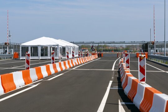 Traffic checkpoint with tents and barriers during the day in a controlled area