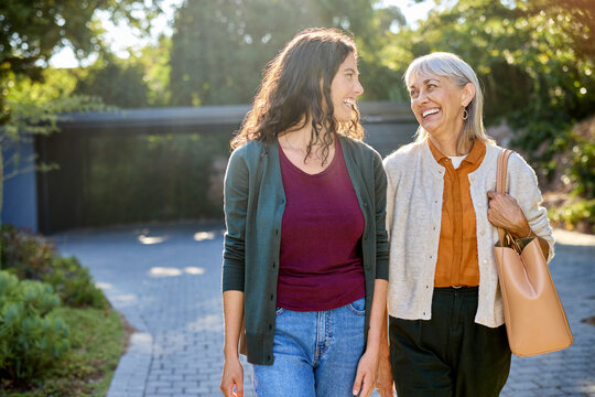 Adult daughter walking with beautiful elder mother