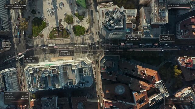 Top down aerial view of Madrid: busy avenue at Plaza de Espana at golden hour with traffic flow heatmap overlay, red density glow on the lanes and congestion readout. Concept of traffic analytics