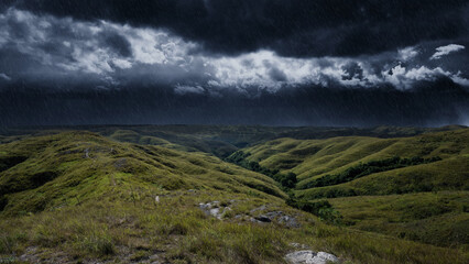 Naklejka premium Dramatic stormy sky with heavy rain falling over rolling green hills and valleys in a rural landscape, creating a moody and atmospheric natural scene. Storm or bad weather background
