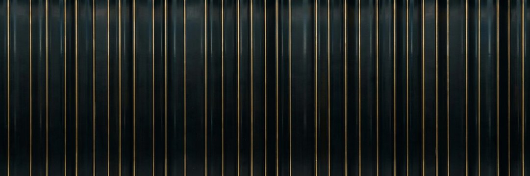 Modern black fluted wall paneling with gold metallic accents, luxury ribbed texture background, architectural vertical slat pattern for interior design