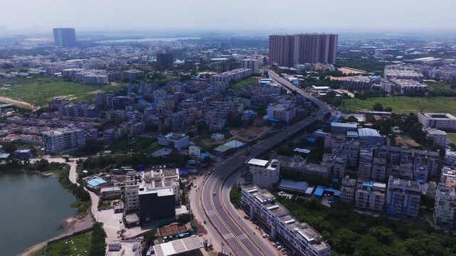 Clouds shadow with Residential buildings, apartments, skylines, lake and flyover at Bachupally, ida bollaram, hyderabad, telangana, india. day time, push in shot, drone shot, 4k.