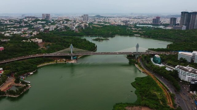 iconic cable stayed bridge with durgam cheruvu, Malkam Cheruvu, green hills and skylines at madhapur, jubilee hills, hyderabad, telangana, india. day time, push back shot, drone shot, 4k.