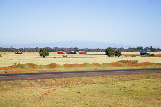 Long-Distance Truck on the Kenya-Uganda Road Through a Wheat Farm