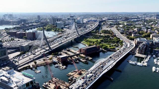Drone flight above the bridges and roads with cars over Charles river. Boston. Massachusetts, USA