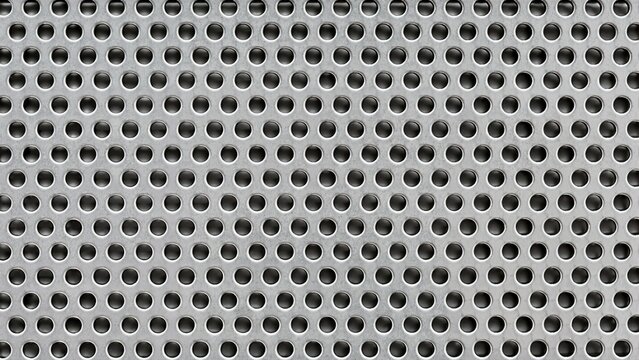 Perforated aluminum sheet metal texture. Grid pattern of round circular holes on brushed silver steel panel