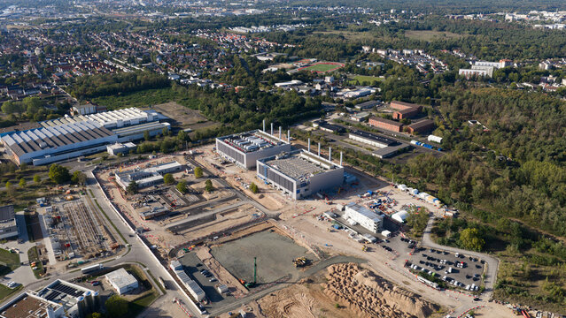 Aerial view of the Data4 Hanau data center facility under construction with large industrial buildings, site infrastructure, and surrounding forest in Hanau, Hessen, Germany.