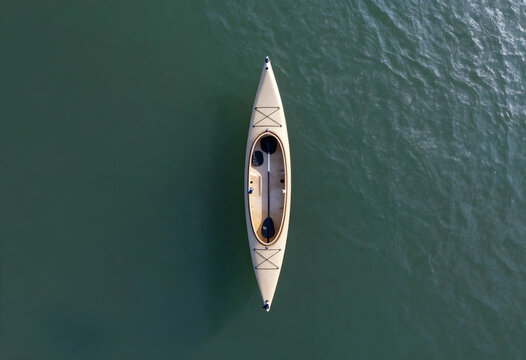Adventure travel and outdoor recreation, empty kayak floating on calm water surface viewed from above for summer vacation and active lifestyle