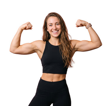 Muscular fitness woman flexing biceps and smiling confidently wearing black athletic clothing indoors