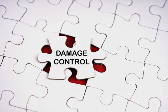 Damage control concept represented by a puzzle piece with bold text surrounded by broken pieces, symbolizing crisis management, problem solving and recovery.