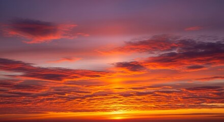 Fototapeta premium Vibrant orange sunset with clouds.