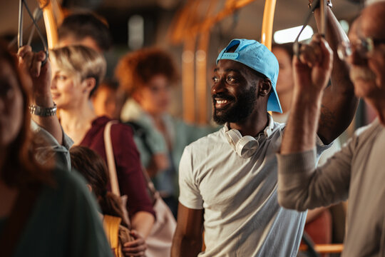 Happy young man commuting on a public bus