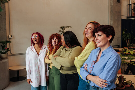 Diverse women friends laughing together sharing happiness