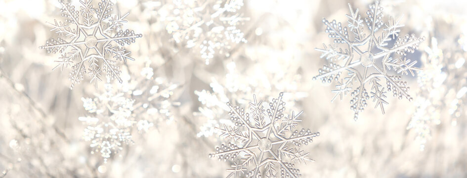 beautiful decorative snowflakes close up on light abstract background. fantasy, fary tale winter nature image. design for Christmas, New Year holidays greeting card. winter festive season. banner