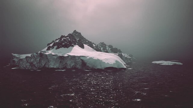 Iceberg floating in dark sea, research vessel context implied with sampling and analysis, evocative of climate crisis fieldwork and sustainability reporting.