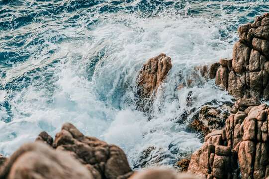 Rough ocean waves crashing on rocky coastline