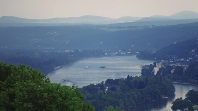 Panoramic aerial view of Rhine river with a few boats on it and island near Bonn in Germany