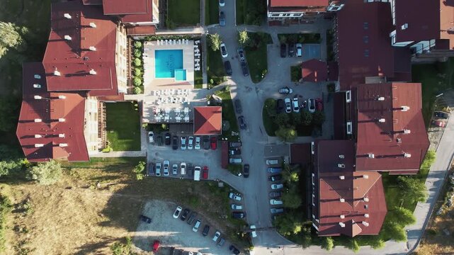A view of a residential area luxury hotel with a lot of cars parked on the street. Aerial shot
