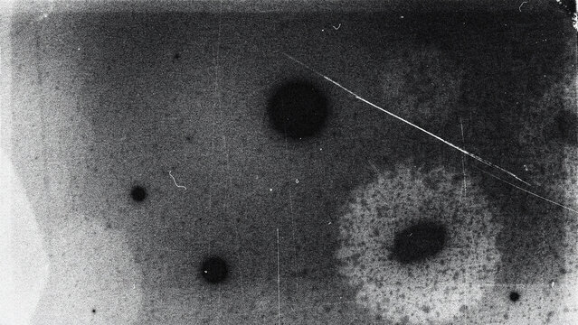 Grainy dark surface with circular spots and scratch texture background scratch mark grunge texture worn surface black background abstract pattern film grain abstract
