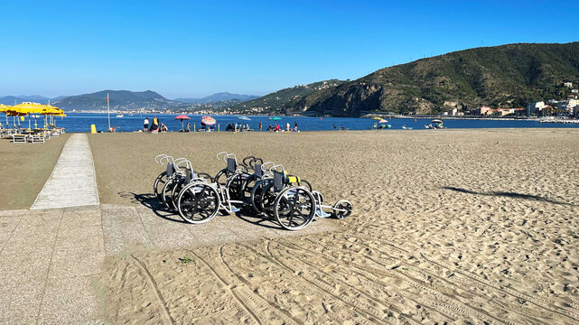 Beach wheelchairs for disabled on sand accessible travel. Inclusive tourism outdoor recreation diversity. Healthcare disability rehabilitation vacation.