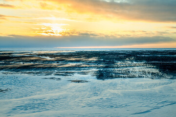 Windblown snow across Route 1 landscape beneath golden winter skies in Iceland  © CharnwoodPhoto