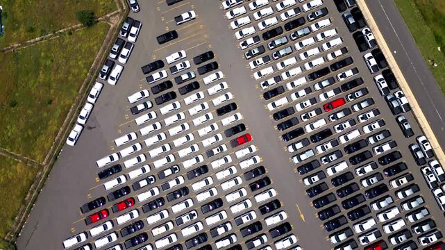 Car factory parking lot with new vehicles for export