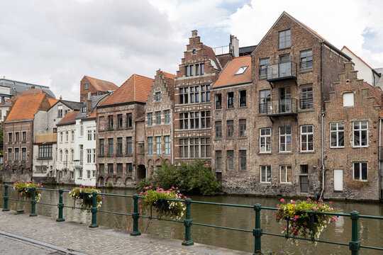Beautiful historic brick houses and architecture along a canal in the city center of Ghent, Belgium, Europe