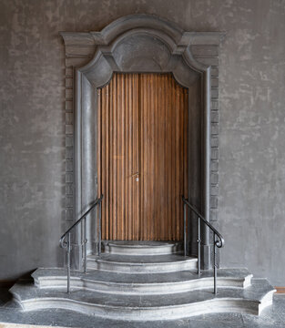 Fancy wooden door in an ornate stone entrance