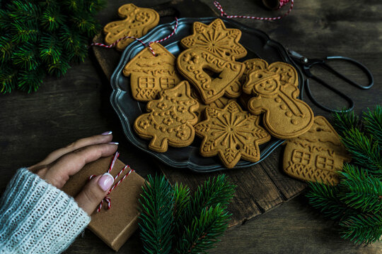 Gingerbread cookies and a holiday gift on a wooden table