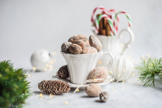 Vintage cup filled with nuts, cinnamon sticks