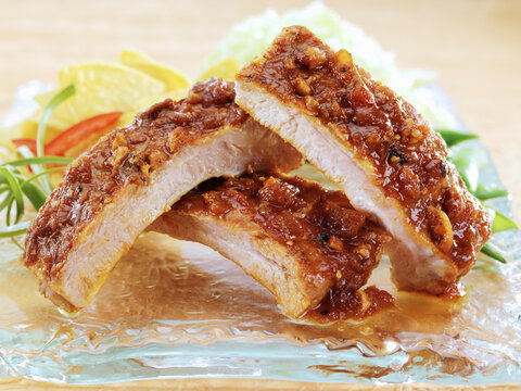 Pork baby back ribs marinated in Asian spices served on glass plate