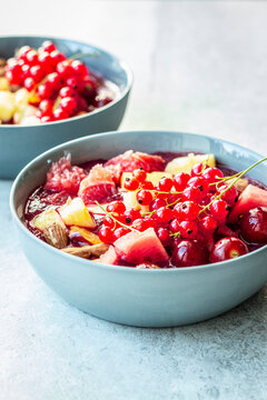 Smoothie bowl with red currants and mixed fruit topping