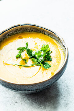 Simple pumpkin soup with coconut milk garnished with parsley
