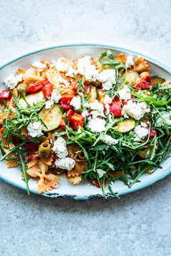 Lukewarm pasta salad with summer vegetables and feta cheese