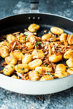 Gnocchi with pulled mushrooms and thyme in a frying pan