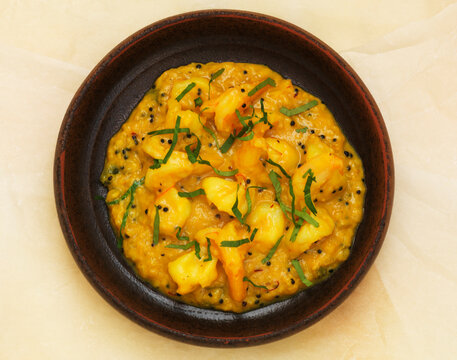 Prawn Moilee curry with coconut sauce and herbs in a bowl