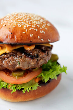 Cheeseburger with grilled beef patty and fresh vegetables